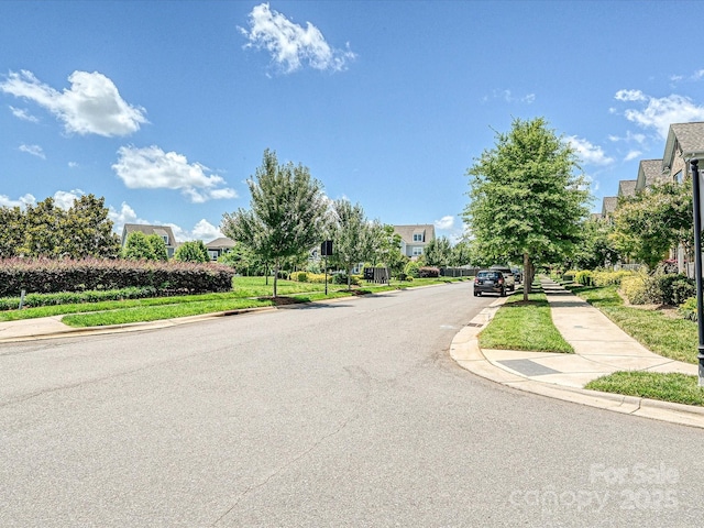 9405 Gladden Hill Ln, Pineville, NC 28134 - view of asphalt road with sidewalks and curbs