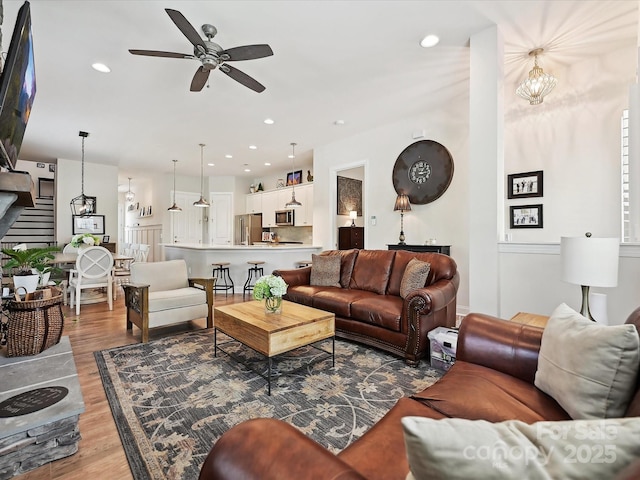 9405 Gladden Hill Ln, Pineville, NC 28134 - living room with wood finished floors, a ceiling fan, stairs, and recessed lighting
