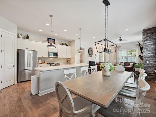 9405 Gladden Hill Ln, Pineville, NC 28134 - dining space featuring wood finished floors, recessed lighting, a ceiling fan, and a chandelier