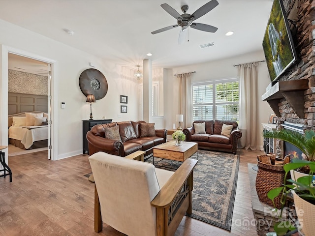9405 Gladden Hill Ln, Pineville, NC 28134 - living room with wood finished floors, a ceiling fan, a stone fireplace, recessed lighting, and baseboards