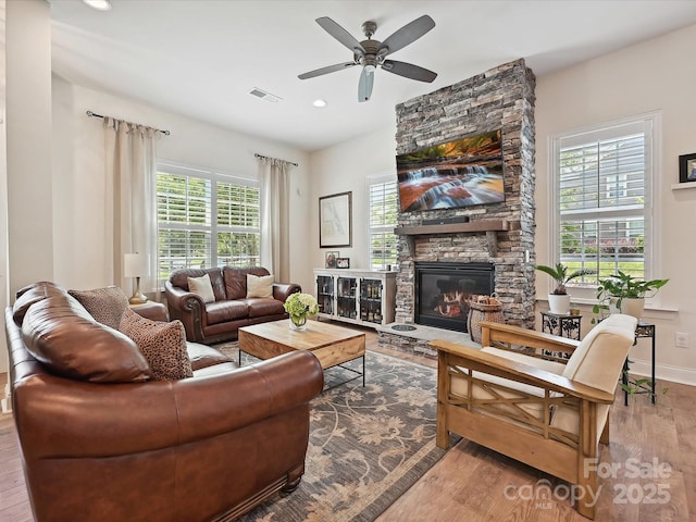 9405 Gladden Hill Ln, Pineville, NC 28134 - living room with wood finished floors, a stone fireplace, a ceiling fan, recessed lighting, and baseboards