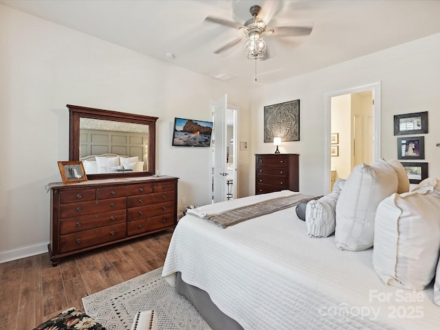 9405 Gladden Hill Ln, Pineville, NC 28134 - bedroom with dark wood-style flooring, baseboards, a ceiling fan, and ensuite bathroom