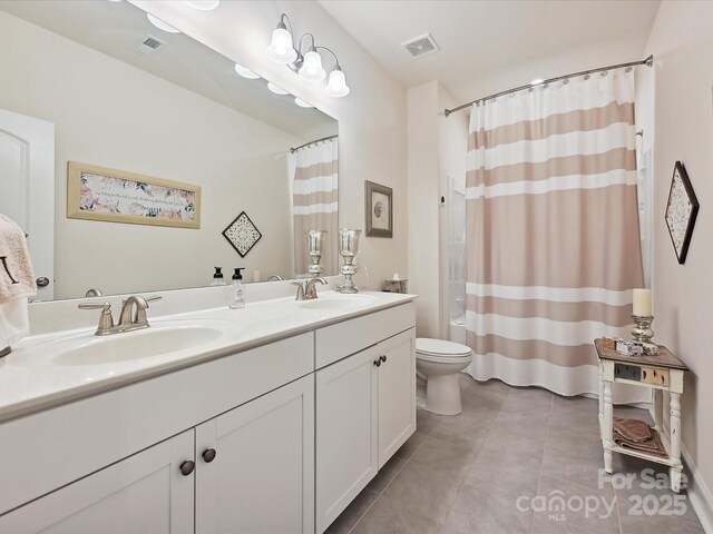 9405 Gladden Hill Ln, Pineville, NC 28134 - bathroom with tile patterned floors, toilet, double vanity, and curtained shower