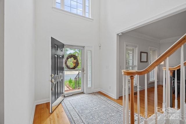 11917 Ulsten Ln, Huntersville, NC 28078 - entryway with wood finished floors, crown molding, stairs, and a towering ceiling