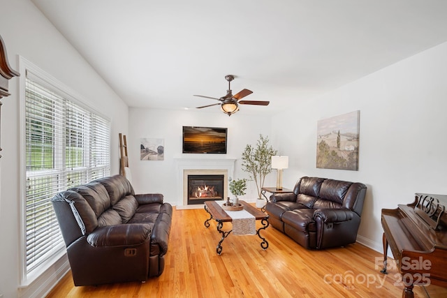 11917 Ulsten Ln, Huntersville, NC 28078 - living area with a fireplace with flush hearth, wood finished floors, and ceiling fan