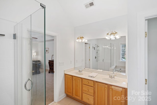 11917 Ulsten Ln, Huntersville, NC 28078 - full bathroom featuring double vanity, a shower stall, a chandelier, a garden tub, and tile patterned floors