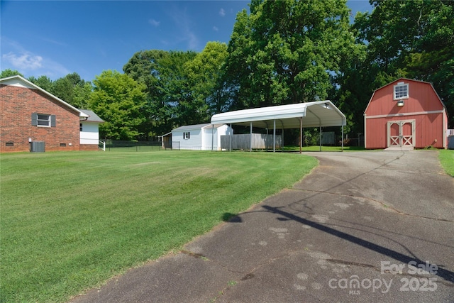 7869 Cherry Point Dr, Denver, NC 28037 - view of yard with asphalt driveway, a detached carport, an outdoor structure, and a barn