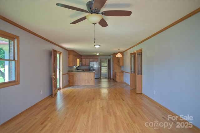 7869 Cherry Point Dr, Denver, NC 28037 - kitchen featuring stainless steel refrigerator with ice dispenser, a peninsula, ornamental molding, light wood-style flooring, and ceiling fan