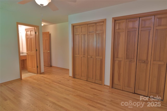 7869 Cherry Point Dr, Denver, NC 28037 - unfurnished bedroom featuring two closets, light wood-style flooring, and a ceiling fan