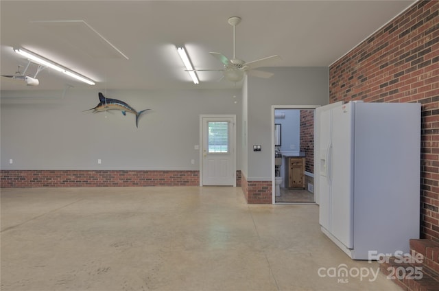 7869 Cherry Point Dr, Denver, NC 28037 - garage with white refrigerator with ice dispenser, ceiling fan, a garage door opener, and a wood stove