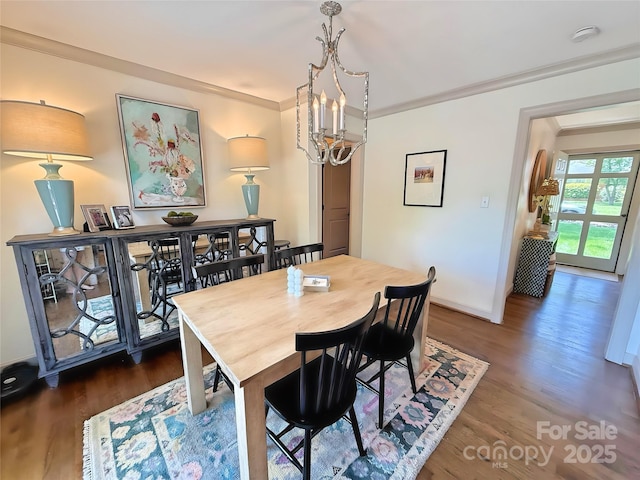 5033 Baylor Dr, Charlotte, NC 28210 - dining area with wood finished floors, a chandelier, crown molding, and baseboards