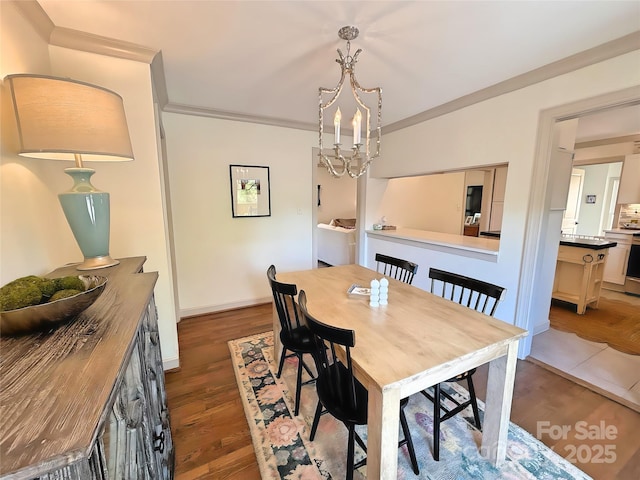 5033 Baylor Dr, Charlotte, NC 28210 - dining room with wood finished floors, ornamental molding, baseboards, and a chandelier