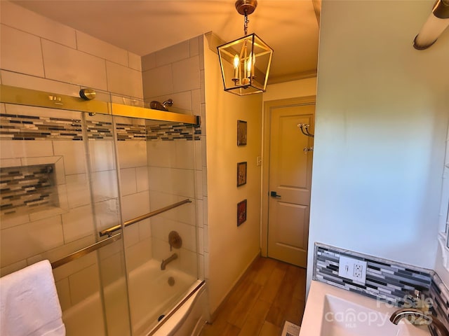 5033 Baylor Dr, Charlotte, NC 28210 - bathroom with wood finished floors, a chandelier, and enclosed tub / shower combo