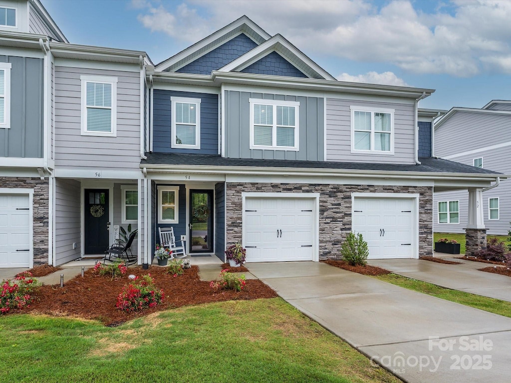54 Woodsdale Pl SE, Concord, NC 28025 - view of property with stone siding, a porch, a garage, driveway, and board and batten siding