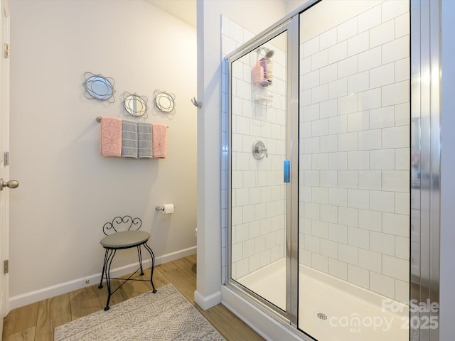 54 Woodsdale Pl SE, Concord, NC 28025 - bathroom with a stall shower, wood finished floors, and baseboards