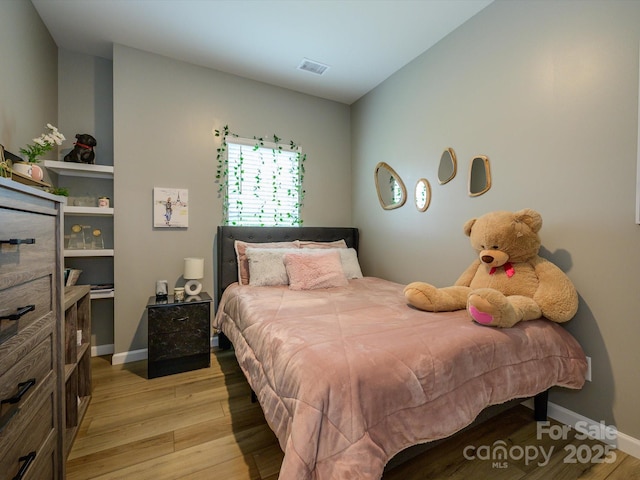 54 Woodsdale Pl SE, Concord, NC 28025 - bedroom featuring light wood-type flooring and baseboards