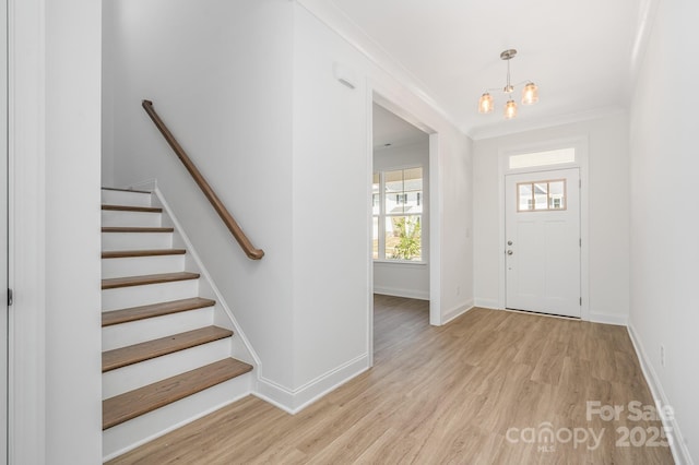 722 Lithia Inn Rd, Lincolnton, NC 28092 - entrance foyer featuring light wood finished floors, a chandelier, baseboards, ornamental molding, and stairs