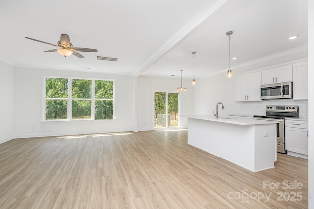722 Lithia Inn Rd, Lincolnton, NC 28092 - kitchen with stainless steel appliances, open floor plan, light wood finished floors, light countertops, and recessed lighting