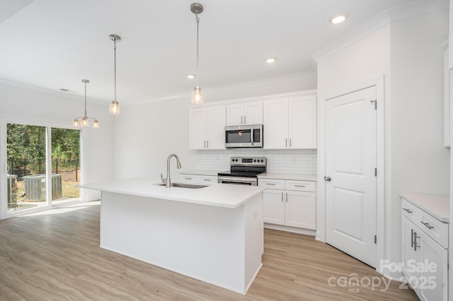 722 Lithia Inn Rd, Lincolnton, NC 28092 - kitchen featuring appliances with stainless steel finishes, a sink, decorative backsplash, light wood finished floors, and crown molding