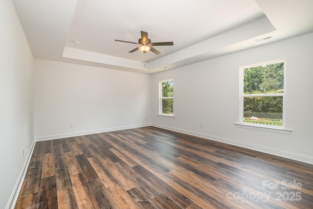 718 Lithia Inn Rd, Lincolnton, NC 28092 - empty room with a raised ceiling, ceiling fan, dark wood-type flooring, and baseboards