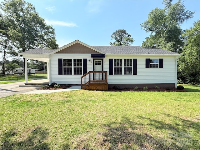 111 W Perry St, Heath Springs, SC 29058 - manufactured / mobile home with a front lawn, a carport, a shingled roof, and driveway