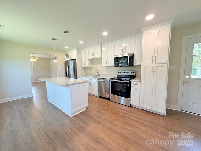 111 W Perry St, Heath Springs, SC 29058 - kitchen featuring stainless steel appliances, a sink, white cabinets, a ceiling fan, and recessed lighting