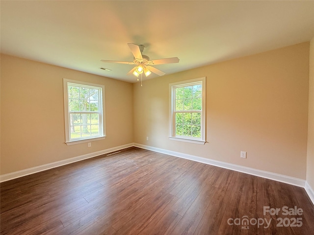 111 W Perry St, Heath Springs, SC 29058 - unfurnished room with healthy amount of natural light, dark wood-type flooring, baseboards, and ceiling fan