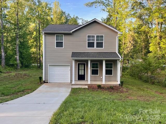 103 Higgins Ct, Morganton, NC 28655 - traditional-style house featuring a porch, concrete driveway, an attached garage, and a front lawn