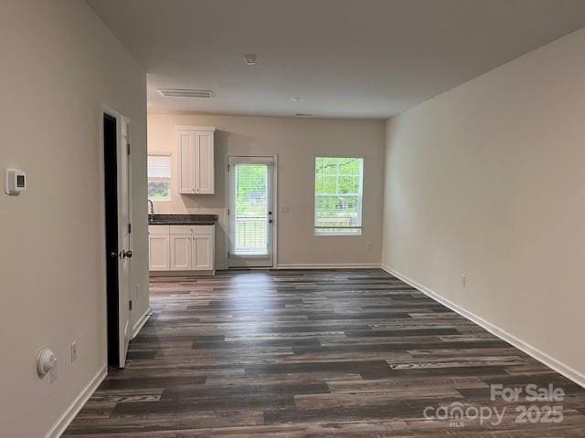 103 Higgins Ct, Morganton, NC 28655 - unfurnished living room featuring dark wood-style flooring and baseboards