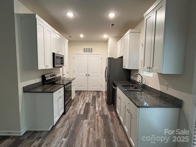 103 Higgins Ct, Morganton, NC 28655 - kitchen featuring stainless steel appliances, a sink, dark wood-style floors, white cabinets, and recessed lighting