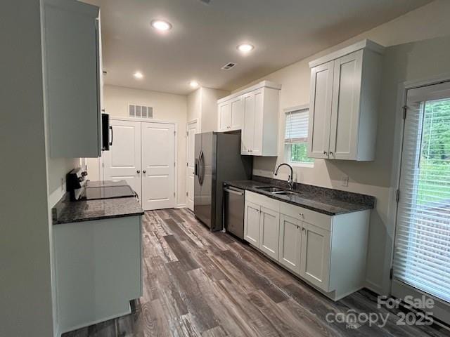 103 Higgins Ct, Morganton, NC 28655 - kitchen with range, dishwasher, a sink, dark countertops, and recessed lighting