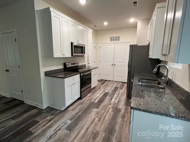 103 Higgins Ct, Morganton, NC 28655 - kitchen featuring appliances with stainless steel finishes, a sink, dark wood-type flooring, white cabinets, and recessed lighting