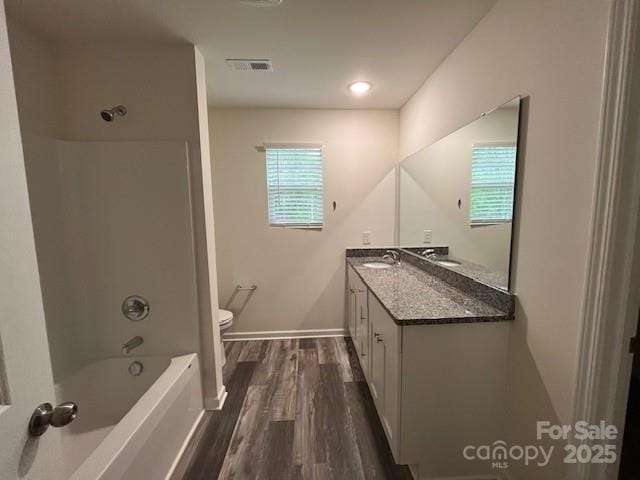 103 Higgins Ct, Morganton, NC 28655 - bathroom featuring vanity, toilet, wood finished floors, shower / bath combination, and baseboards