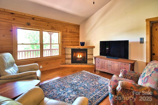 496 Moonlight Pass, Union Mills, NC 28167 - living room with wood finished floors, wooden walls, a stone fireplace, and vaulted ceiling