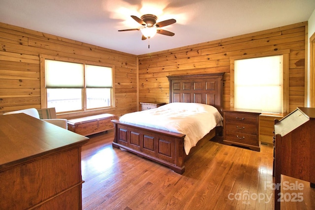 496 Moonlight Pass, Union Mills, NC 28167 - bedroom featuring wood finished floors, wood walls, and ceiling fan