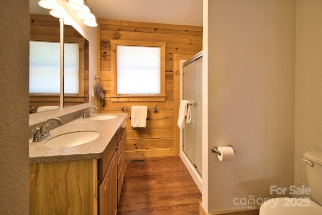 496 Moonlight Pass, Union Mills, NC 28167 - bathroom featuring healthy amount of natural light, toilet, a shower stall, double vanity, and wood walls