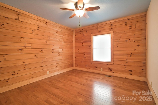 496 Moonlight Pass, Union Mills, NC 28167 - spare room featuring a ceiling fan, wood finished floors, and wooden walls