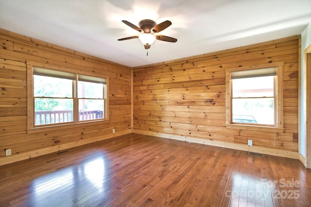 496 Moonlight Pass, Union Mills, NC 28167 - empty room with plenty of natural light, a ceiling fan, wood finished floors, and wood walls