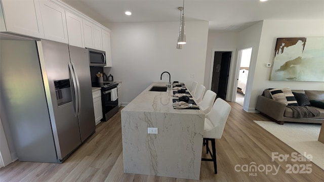 6386 Cathedral Dr, Granite Falls, NC 28601 - kitchen with appliances with stainless steel finishes, a sink, light wood finished floors, white cabinets, and recessed lighting