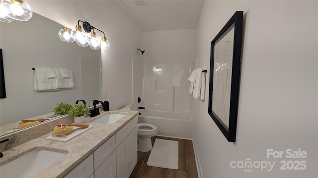 6386 Cathedral Dr, Granite Falls, NC 28601 - full bathroom with toilet, double vanity, wood finished floors, and shower / bath combination