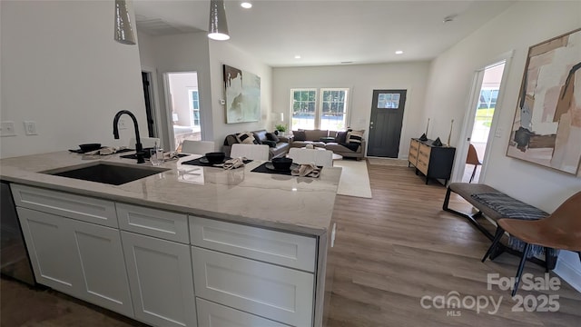 6386 Cathedral Dr, Granite Falls, NC 28601 - kitchen with a sink, dark wood-style flooring, light stone counters, recessed lighting, and open floor plan