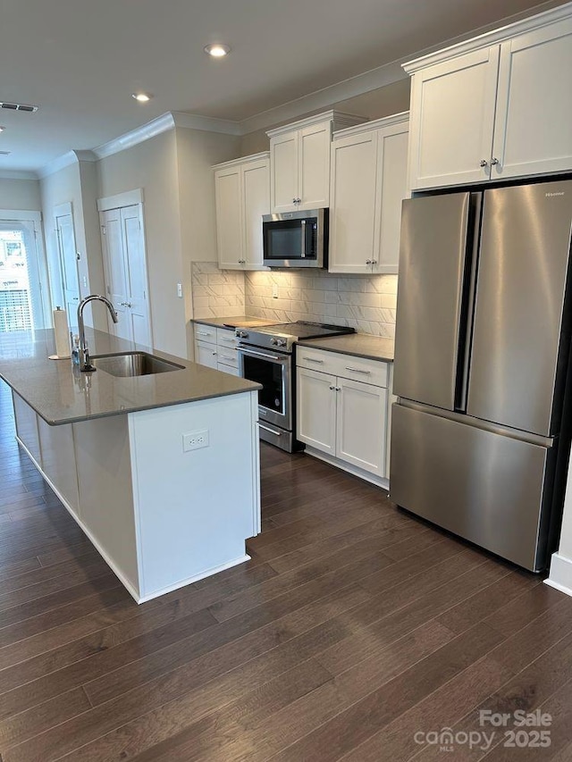 3007 Citizens Ln, Charlotte, NC 28205 - kitchen featuring appliances with stainless steel finishes, a sink, crown molding, white cabinetry, and dark wood-style floors