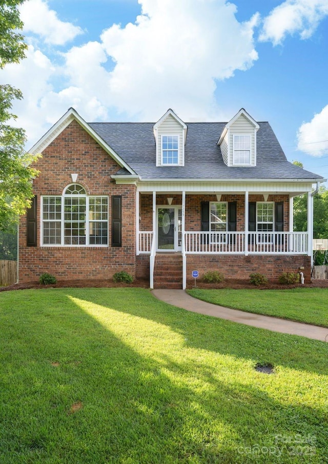 7255 Orchard Path Dr, Clemmons, NC 27012 - cape cod-style house with a front yard, brick siding, covered porch, and a shingled roof