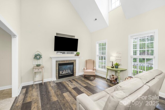 7255 Orchard Path Dr, Clemmons, NC 27012 - living area featuring high vaulted ceiling, dark wood finished floors, a tiled fireplace, and baseboards