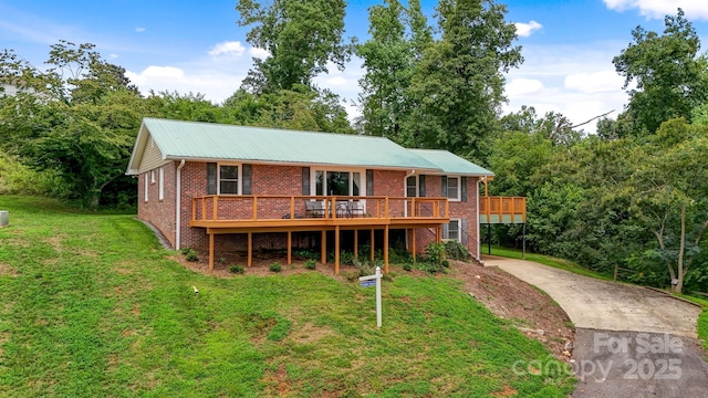 6294 Southlake Dr, Hickory, NC 28601 - rear view of house featuring concrete driveway, brick siding, a yard, and a deck