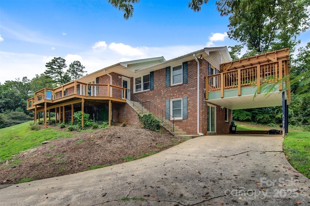 6294 Southlake Dr, Hickory, NC 28601 - back of property featuring concrete driveway, brick siding, and a wooden deck