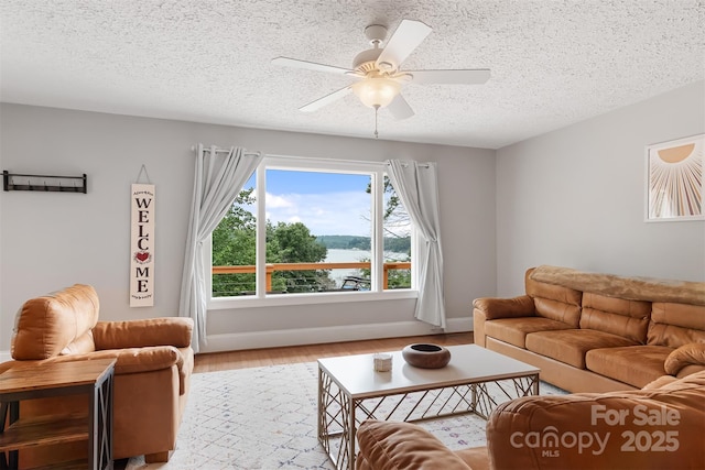 6294 Southlake Dr, Hickory, NC 28601 - living room featuring a textured ceiling, light wood-type flooring, ceiling fan, and baseboards