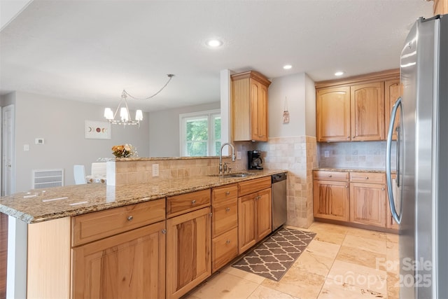 6294 Southlake Dr, Hickory, NC 28601 - kitchen with a sink, stainless steel appliances, a peninsula, light stone countertops, and tasteful backsplash