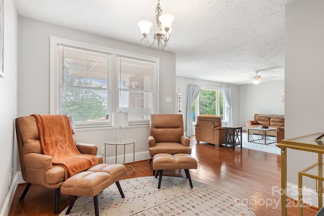 6294 Southlake Dr, Hickory, NC 28601 - sitting room with a textured ceiling, a chandelier, wood finished floors, ceiling fan, and baseboards