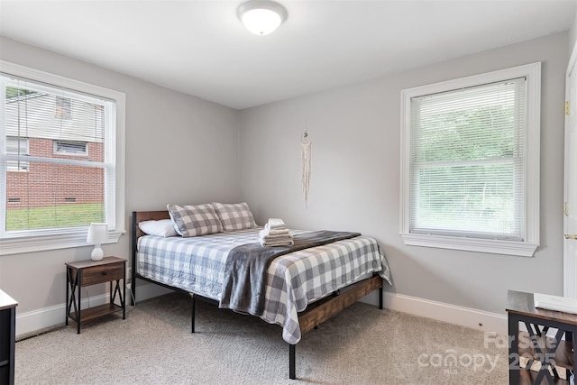 6294 Southlake Dr, Hickory, NC 28601 - bedroom with multiple windows, baseboards, and light carpet